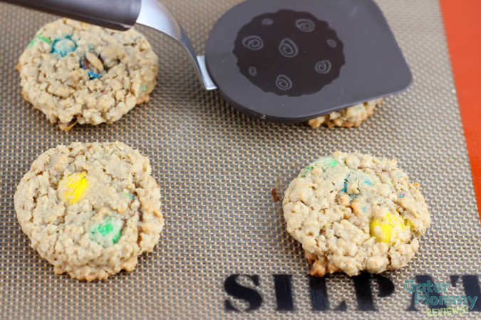 Using a spatula to flatten M&M's® Oatmeal Cookies